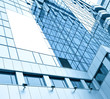 blue glass wall with blank placard of skyscraper