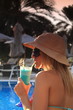 Drinking a cockatil by the pool Drinking a cockatil by the pool