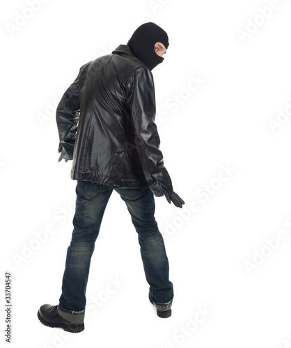 Photo: young male thief in balaclava and black leather jacket young male thief in balaclava and black leather jacket