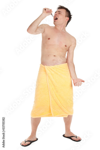 Photo: shaving young man in yellow towel with razor shaving young man in yellow towel with razor