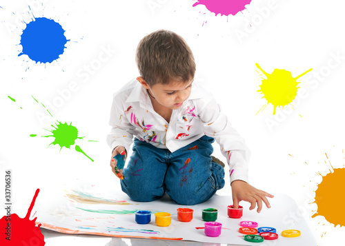 Photo: Cute little boy covered in bright paint Cute little boy covered in bright paint