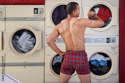 Photo: Half-naked Man in Laundromat Half-naked Man in Laundromat