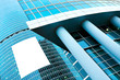 blue glass wall with blank placard of skyscraper