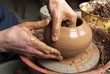 hands of a potter, creating an earthen jar on the circle hands of a potter, creating an earthen jar on the circle