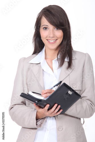 Foto: Young woman scheduling an appointment Young woman scheduling an appointment