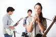 a guitar player, a drummer and a female singer