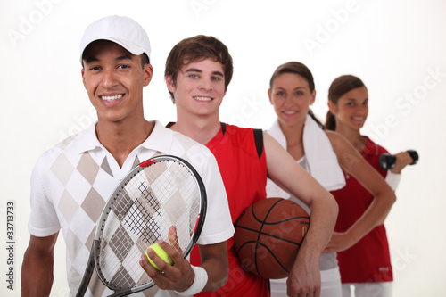 Photo: Four teenagers dressed for different sports Four teenagers dressed for different sports