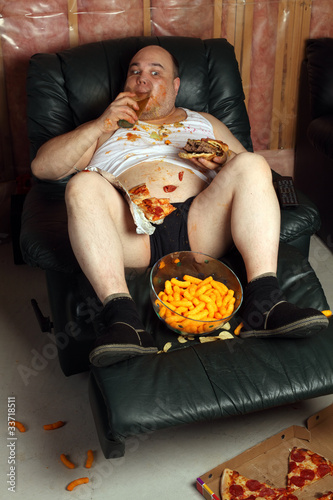 Photo: Hamburger eating lazy couch potato Hamburger eating lazy couch potato