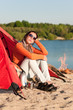 Camping beach woman by campfire in tent