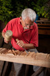 woodcarver working with mallet and chisel woodcarver working with mallet and chisel
