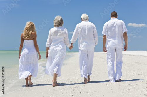 Photo: Four People, Two Seniors, Family Couples, Walking On Beach Four People, Two Seniors, Family Couples, Walking On Beach