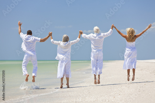 Photo: Four People, Two Seniors, Family Couples, Jumping On Beach Four People, Two Seniors, Family Couples, Jumping On Beach