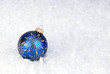 single blue Christmas ornament on snow - good card background