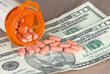 prescription pills on background of fifty dollar bills