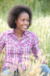 black woman sitting and relaxing in a field