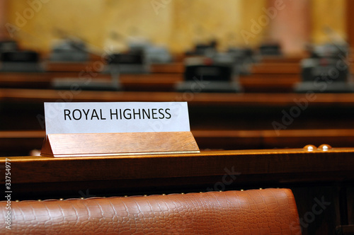 Photo: empty Royal Highness seat in conference hall empty Royal Highness seat in conference hall