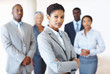 Photo: Female executive with colleagues in background Female executive with colleagues in background