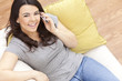 Happy Hispanic Woman Using Cell Phone At Home