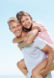 Photo: Man giving woman piggyback ride Man giving woman piggyback ride