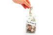 hand putting a dollar into a jar - education saving