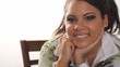 Young pretty latina sitting and smiling