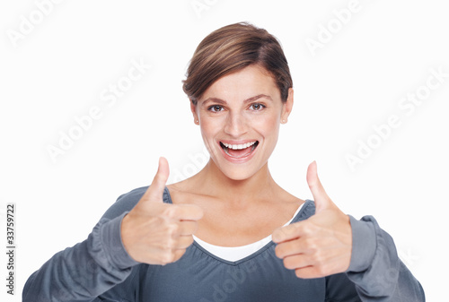 Photo: Woman gesturing thumbs up Woman gesturing thumbs up