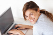 Woman using laptop while relaxing