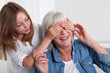 Girl hiding her grandmother's eyes