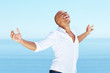 Happy young man standing with arms outstretched