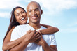 Young couple having fun together against the sky