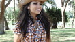 Pretty woman listening to music in the park