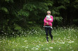 Mother with baby walking in meadow