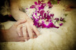 bride and groom's hands holding wedding bouquet