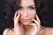 Woman with professional colourful make-up and sparkling manicure