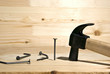 Four nails and hammer on a board