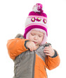 Adorable toddler girl dressing winter jacket and hat
