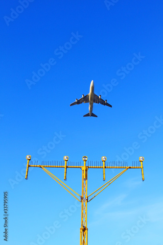 Photo: Plane fly up over take-off runway from airport at daytime Plane fly up over take-off runway from airport at daytime