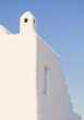 Fragment of a Greek white building with stairs in the sky.