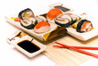 Sushi with chopsticks against white background. Sushi with chopsticks against white background.