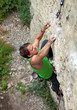Photo: Rock climber struggling to reach next handhold Rock climber struggling to reach next handhold