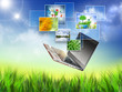 Multimedia concept with modern laptop on green field Multimedia concept with modern laptop on green field