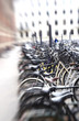 A lens blurred photo of lots of parked bikes.