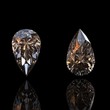 Photo en ligne au meilleur prix Jewelry gems on black background. Pear