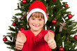 mädchen mit weihnachtsmütze zeigt beide daumen hoch mädchen mit weihnachtsmütze zeigt beide daumen hoch