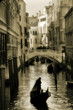 Gondola silhouette on venetian canal.