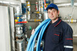 heating engineer repairman in boiler room