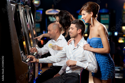 Photo: friends playing the slots friends playing the slots