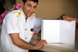 Photo: Bellboy holding a blank notebook for your text image vignetted. Bellboy holding a blank notebook for your text image vignetted.