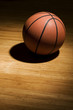 Photo: Basketball sitting on wood floor Basketball sitting on wood floor