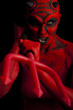 Devil attacking with her trident, black background.